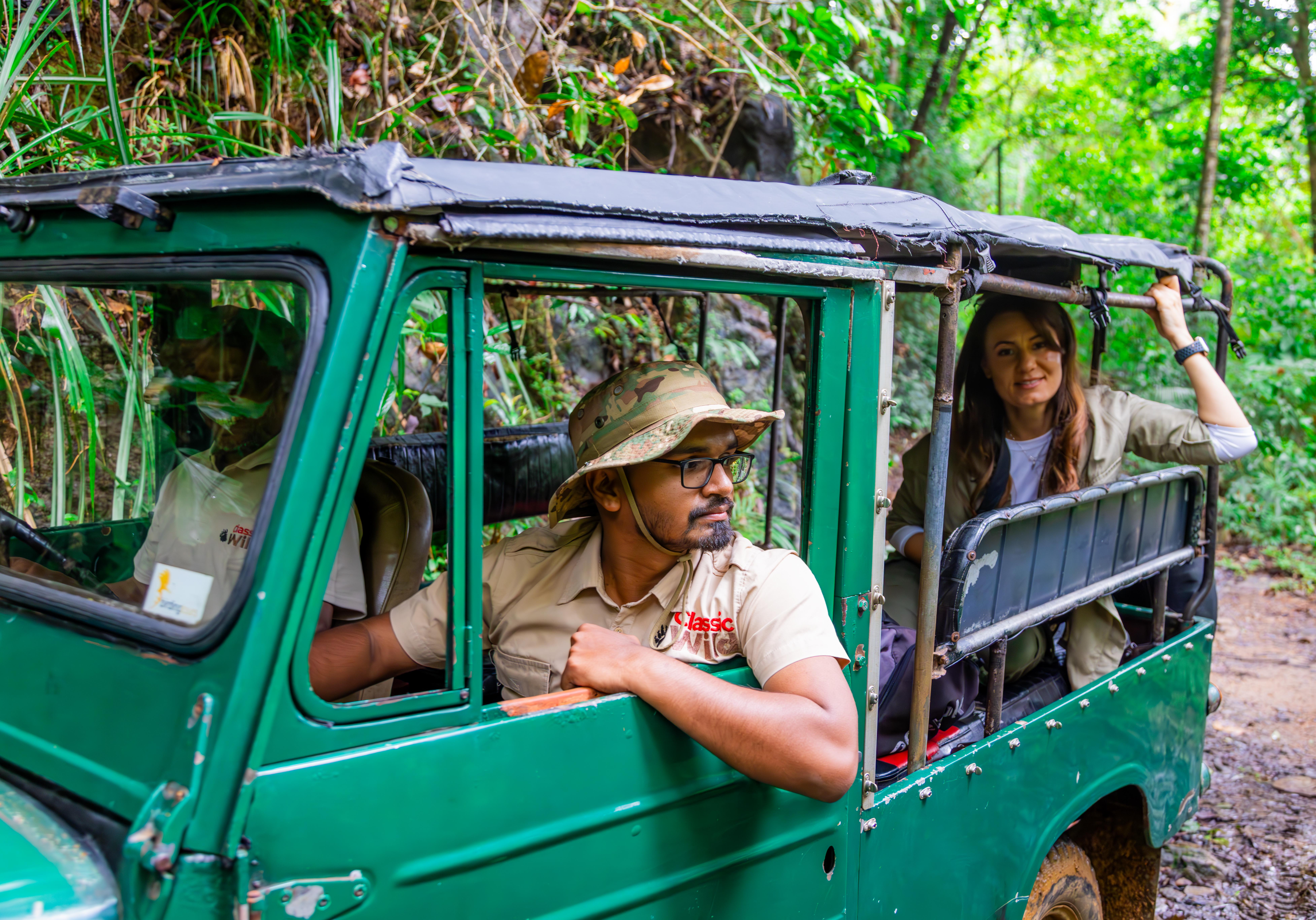 Classic Wild naturalist and a guest in an open safari jeep on a rainforest track in Sri Lanka